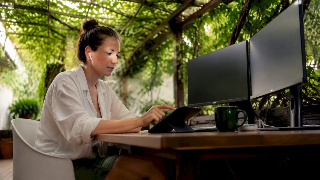 Creator using online tip jar on tablet at home studio