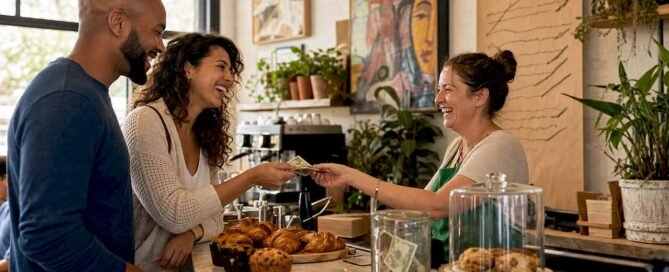 Small business owner receiving tip from customers