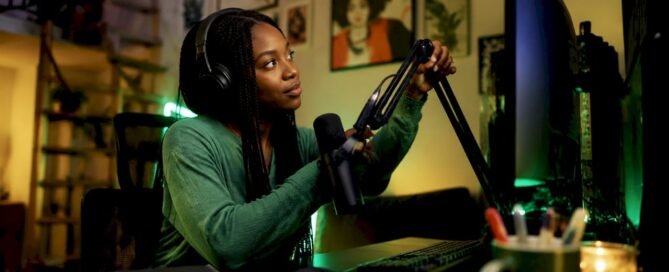 Streamer adjusting microphone in home studio