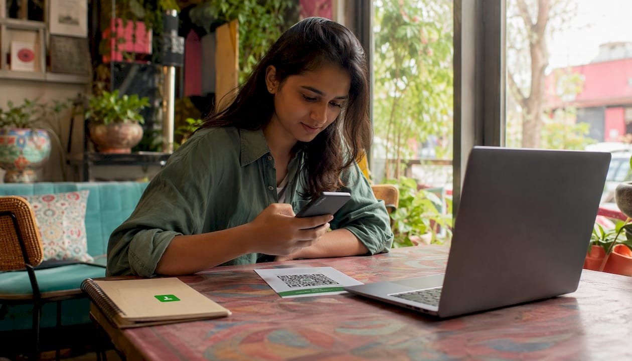 Freelancer scanning payment QR code at desk