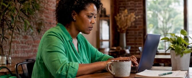 Creator managing finances at laptop