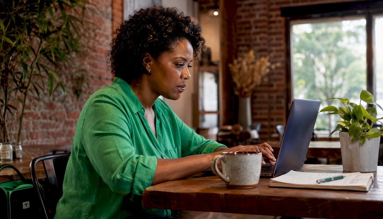 Creator managing finances at laptop