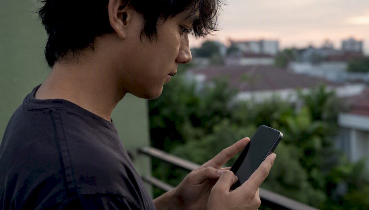 Person examining phone for payment link safety