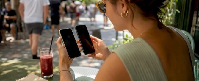 Hands holding two phones checking tipping links