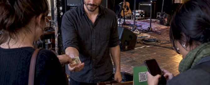 Musician receiving cash and digital tips