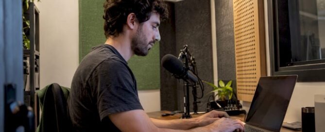 Podcaster editing episode notes beside a microphone