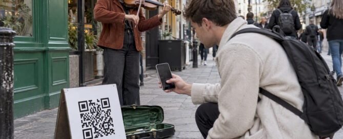 Street musician beside a scanned QR sign